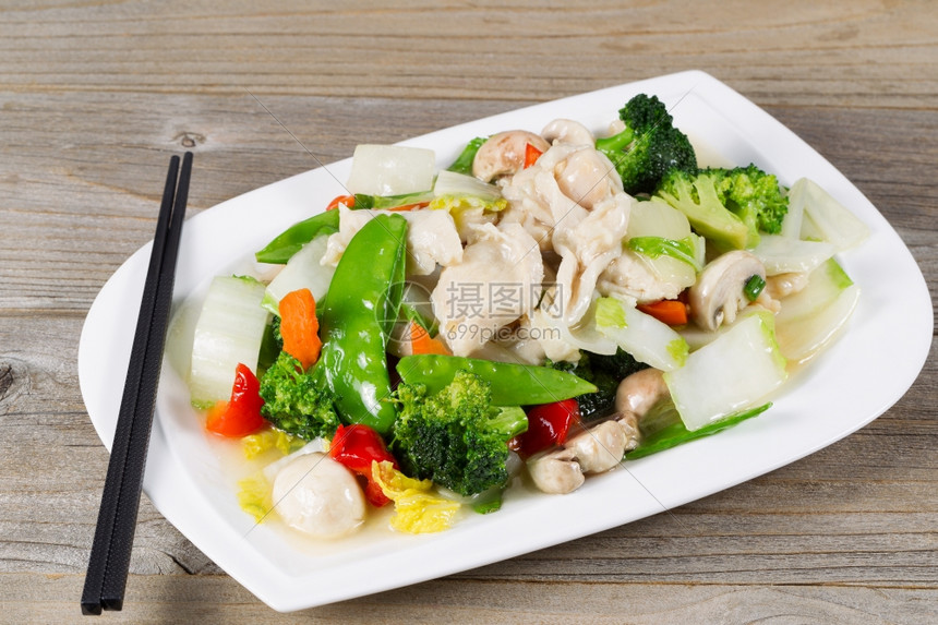 白色盘子里的青菜花椰雪梨胡椒和蘑菇图片