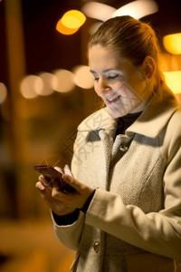 快乐女在街上阅读短信的夜特辑肖像图片