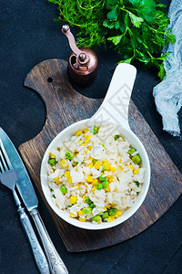 碗里和桌子上加蔬菜的米饭图片