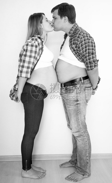 黑色和白有趣的画像怀孕夫妇面对的亲吻图片