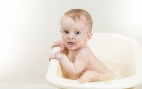 可爱的婴儿男孩头上有泡沫的婴儿男孩洗澡时间图片