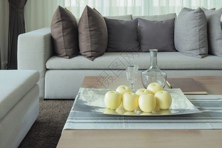 用沙发和枕头设计现代客厅的木制桌上水果图片