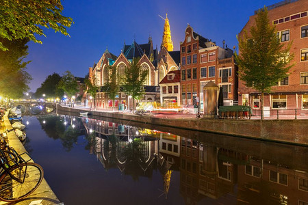 阿姆斯特丹红灯区DeWalllen夜间红灯区DeWalllen运河OudezijdsWirburgwal和Oude教堂及其镜像反图片