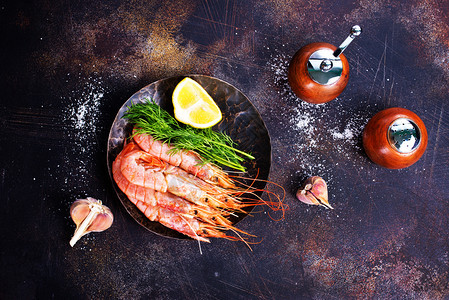 餐桌上加盐和香料的煮虾图片
