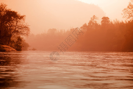 迷雾神秘的河流和森林景观红色的音调图片