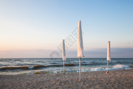 清晨海滩上的白雨伞图片