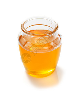 白色背景上隔绝的玻璃罐蜂蜜图片