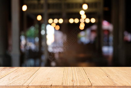 咖啡店的抽象模糊背景面前的空黑木桌可以用于显示或装配您的产品装上以显示产品图片