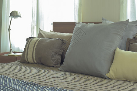 在现代日式本卧室床上铺大小不同单衬枕头图片