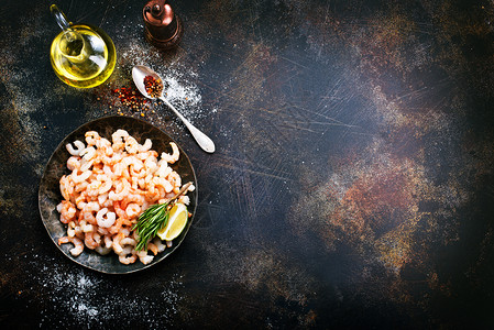 盘上加胡椒和盐的煮虾图片