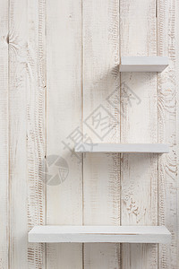 白色墙壁背景纹理上的木架图片