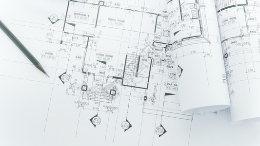 建筑师工作场所建筑蓝图上面有测量胶带安全头盔和桌面上的工具图片