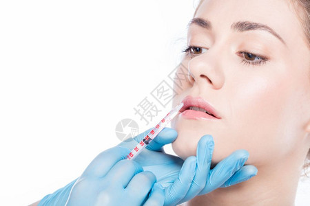 美学年轻人正在注射唇膏抗皮肤护理和整形外科概念年轻美人有唇膏注射图片