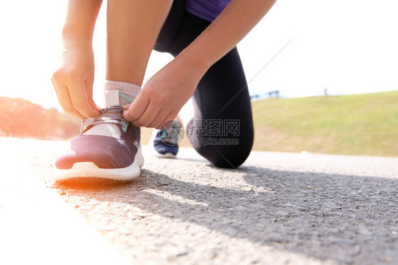与跑鞋慢者医疗保健和福利概念捆绑在一起的活跃健康妇女图片