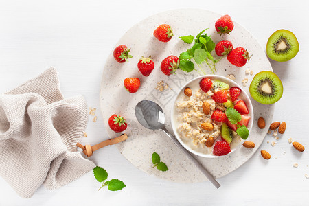 有燕麦粥草莓坚果的美味早餐背景图片