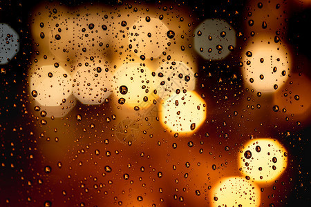 Bokeh街灯上玻璃窗的雨滴图片