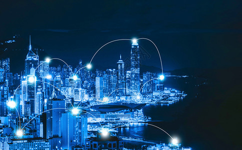 香港市中心与维多利亚港的数码网络连接线路智能城市金融区在技术概念上天桥和高楼建筑夜间空中观察图片