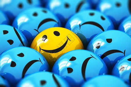 创意抽象成功与人情感概念在带选择焦点效果的乏味忧郁蓝面球图标或按钮中对快乐的黄色微笑脸球图标或按钮的宏观点图片