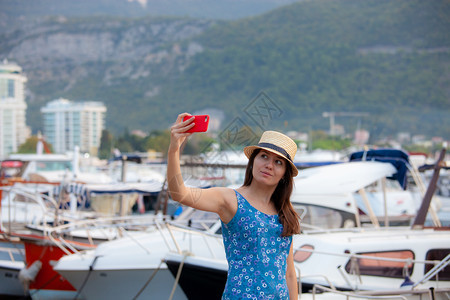 欧洲在著名的地中海目暑假期间带着智能手机拍摄自画像图片