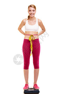滑坡和体重减退快乐的年轻女孩以体重的磁带测量健康的生活方式概念孤立于白色快乐的女士体重测量图片
