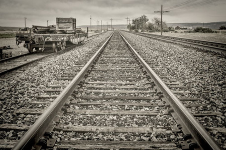 铁轨上一辆火车修理板车的黑白图像图片