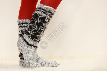 冬季时穿冬服装的女子双腿羊毛暖和袜子红色紧身裤穿羊毛袜子和红色紧身裤的女子双腿背景图片