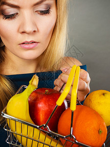 购买健康食品素无用等产品持有内装水果的购物车不幸妇女持有内装水果的购物篮妇女持有内装水果的购物篮妇女图片
