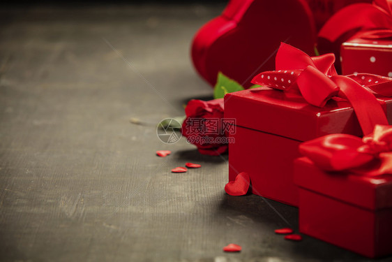 ValentierDay概念在木制背景上带有红弓的礼物在生锈背景上绑红色讽刺丝带弓的礼物盒Valentier日概念图片