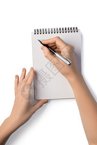 妇女持有笔并用记本写作白纸上孤立的笔记本妇女持有笔并用记本写作图片