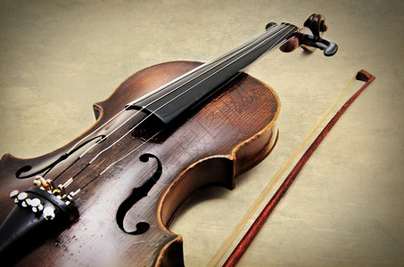 古老的小提琴在土纸质纹理上背景图片
