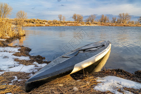 在科罗拉多湖上站起滑板早期春风景和雪图片