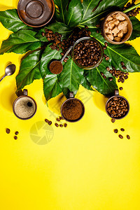 具有创意的平板铺黄色背景和热带叶的咖啡图片