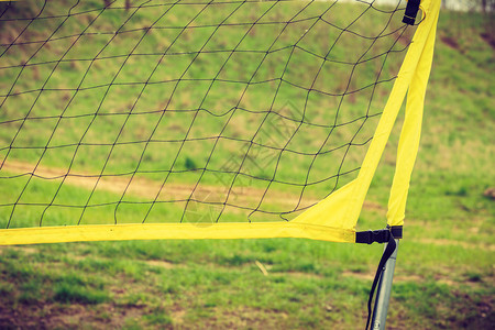 体育设备运动外面的娱乐村操场上的黄色排球网户外村操场上的排球网外面体育设备图片