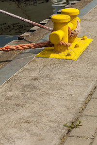 船用物体概念在黄码头上挂着的绳子在阳光明媚的一天外门拍摄在阳光照耀的灯针上挂着绳子图片