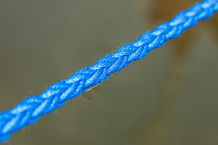 物体连接强度航行设备概念光照下厚蓝色绳索的详细封闭厚蓝色绳索的详细封闭图片