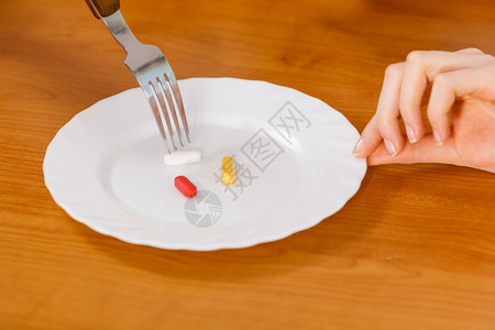 服用避孕药的人吃一盘的药品保健和医疗条件概念三盘的药丸背景图片