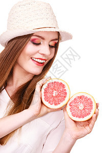具有吸引力的长发女子的多彩双眼化妆将两半的葡萄果柑橘水握在手中健康饮食品暑假概念妇女将两半的葡萄果柑橘水握在手中图片