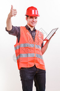 身穿安全背心戴平板硬帽的英俊男子工人上班的修理工检查员带平板工人的男图片