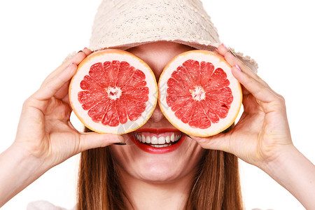 有吸引力的长发女子拿着葡萄水果切片看白微笑女子建议健康食物暑假幸福概念用两半葡萄果柑橘水遮住眼睛图片
