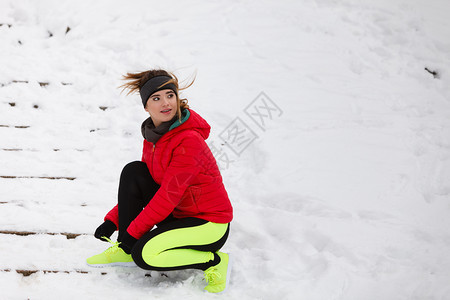 冬季运动时装概念妇女把运动健身鞋绑在雪中把鞋绑在外面锻炼冬季妇女把运动鞋绑在上图片