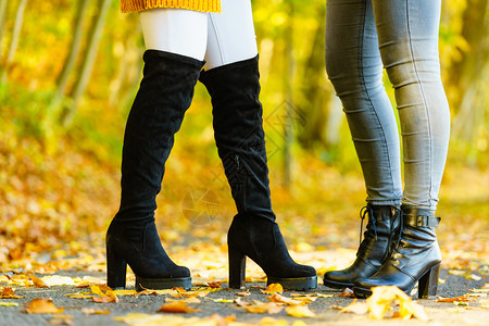 穿着黑色暖鞋和高膝靴的妇女在秋天时穿着黑色暖鞋和高膝靴无法辨认图片