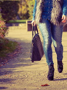 时尚女孩穿着装在公园里行走是户外模特儿的一部分图片
