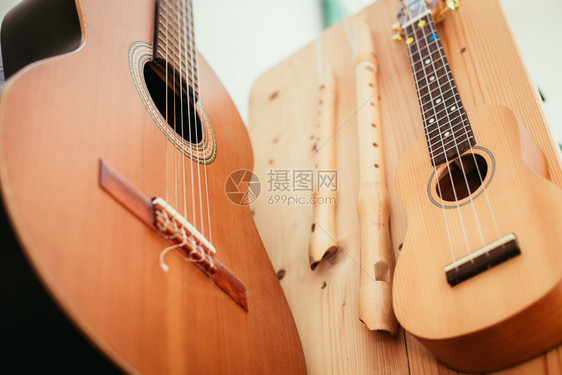 Ukulele挂在木书架上图片