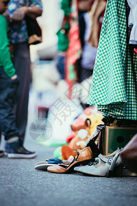 在跳蚤市场上的鞋子裙和东西模糊背景的人图片