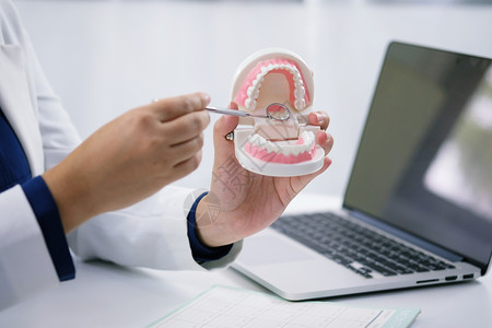 牙医在科办公室检查病人牙齿治疗图片
