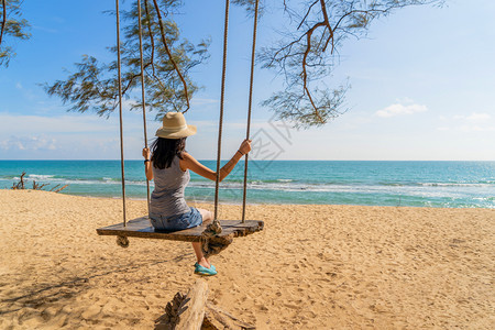 快乐的亚洲女在泰国普吉中午的海洋或自然户外度假旅行中在海滩上摇晃图片