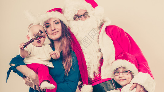 与圣诞老人一起快乐的家庭母亲女儿和圣诞父亲的肖像图片