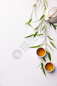 亚洲食物背景包括绿色茶叶杯和壶竹枝白底文字自由空间图片
