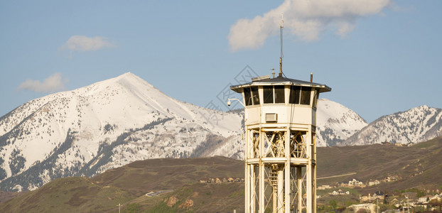 蓝天和雪覆盖山站在监狱看守的望塔后面图片