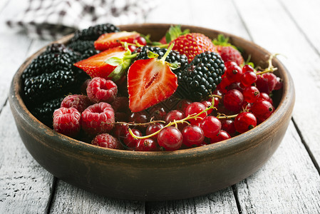 碗里的浆果在桌子上新鲜的浆果图片